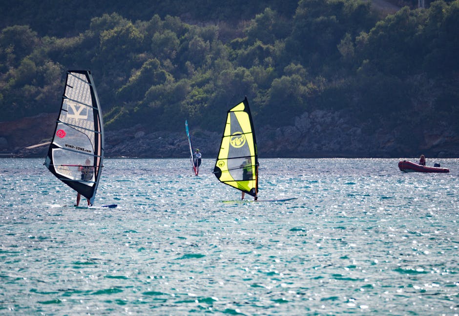 Dynamic windsurfing scene in Evritania, Greece, with people enjoying water sports.